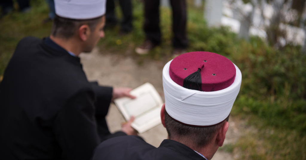Muslim men reading at an islamic burial