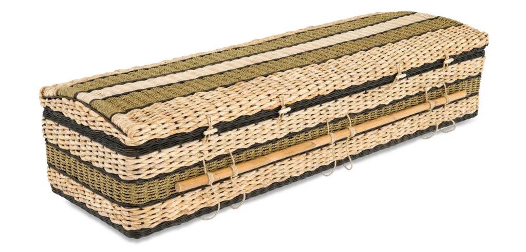 A rectangular wicker coffin with alternating light and dark woven bands, secured with rope handles and loops, and a gently curved lid—ideal for natural burial alongside biodegradable urns for water burial in Australia. by H Parsons Funeral Directors