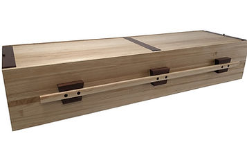 A simple, rectangular wooden coffin with visible grain, dark brown corner accents, and two wooden handles on the side. by H Parsons Funeral Directors