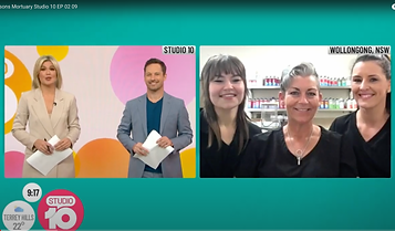 Split-screen TV broadcast: On the left, two smiling presenters stand holding papers in front of a colourful Studio 10 backdrop; on the right, three women in black attire smile inside a brightly lit room labelled "Wollongong, NSW. by H Parsons Funeral Directors