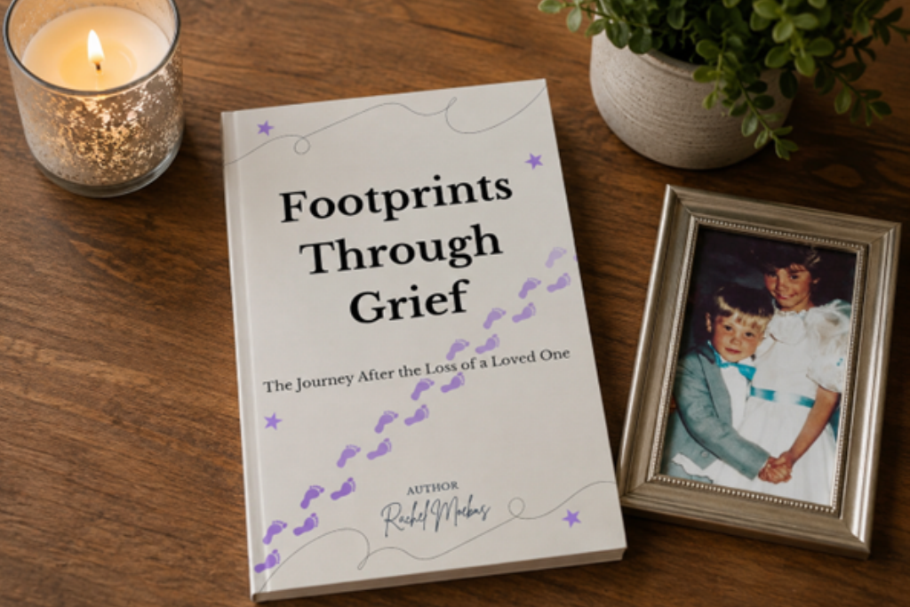 The book Footprints Through Grief: The Journey After the Loss of a Loved One rests on a wooden table next to a lit candle, a small potted plant, and a framed photograph of two children, offering support for understanding grief. by H Parsons Funeral Directors